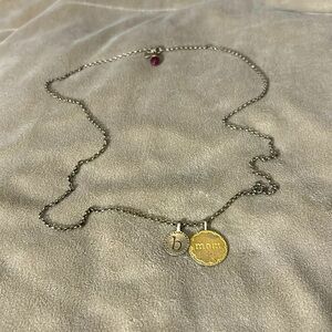 GOLD MOM STAMPED CIRCLE PENDANT WITH THE LETTER B AND THE JULY BIRTHSTONE CHARM